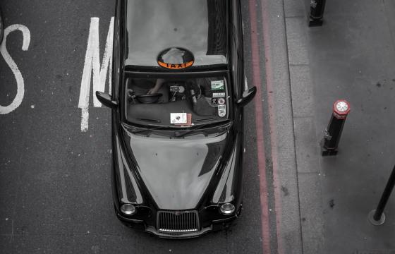 Picture of a black taxi from above. 